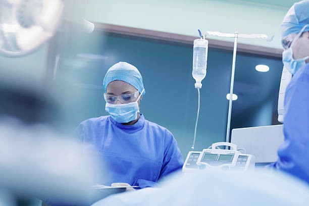 Doctors performing surgery in hospital operating room